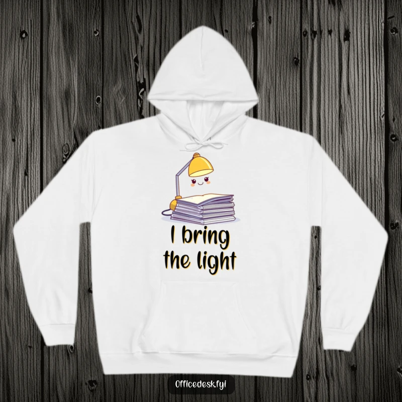 Funny desk lamp hoodie, a miniature grinning lamp character lighting up a pile of papers, cozy work humor apparel.